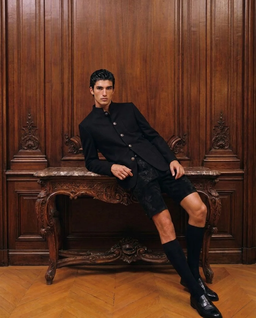 Fratz Janker and embroidered Lederhose in a wood-panelled Viennese salon
